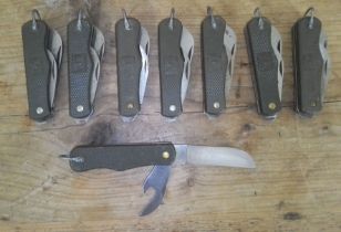 A group of eight Italian army penknives with eight knife pouches.