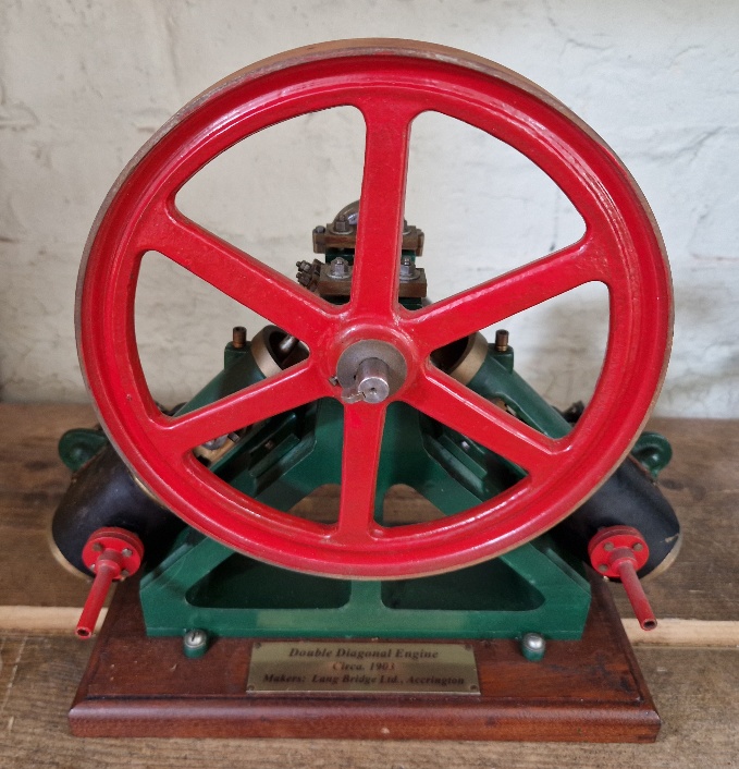 A well engineered model of a live steam double diagonal stationary engine on wooden base, size of