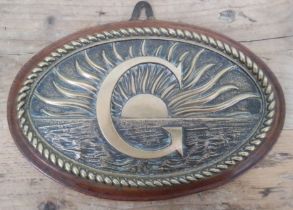 A maritime brass plaque and oak board, length 26cm.