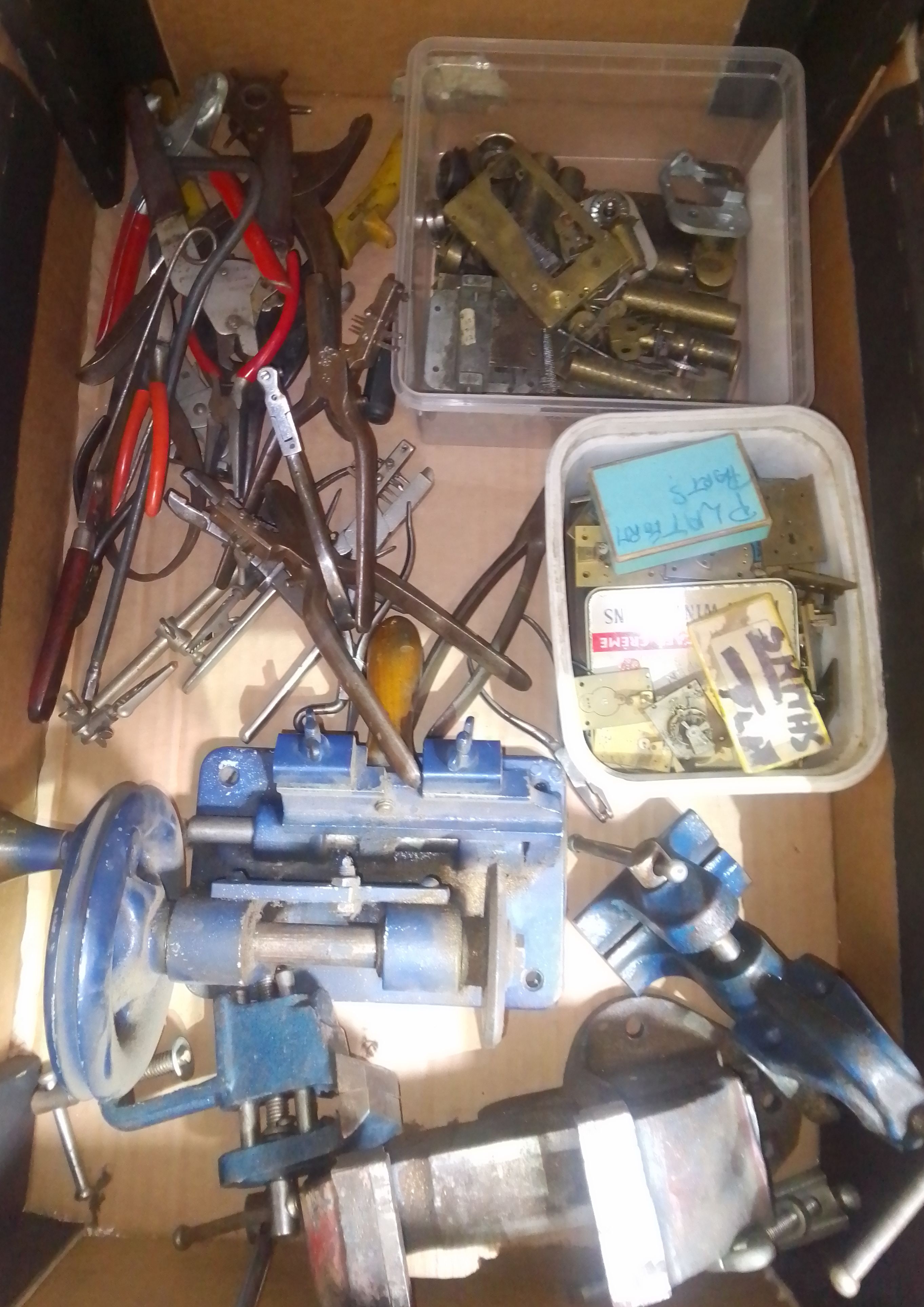 A box of mainly assorted horologist's spares and tools.