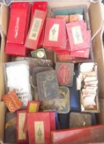 A box of mainly assorted horologist's spares and tools.