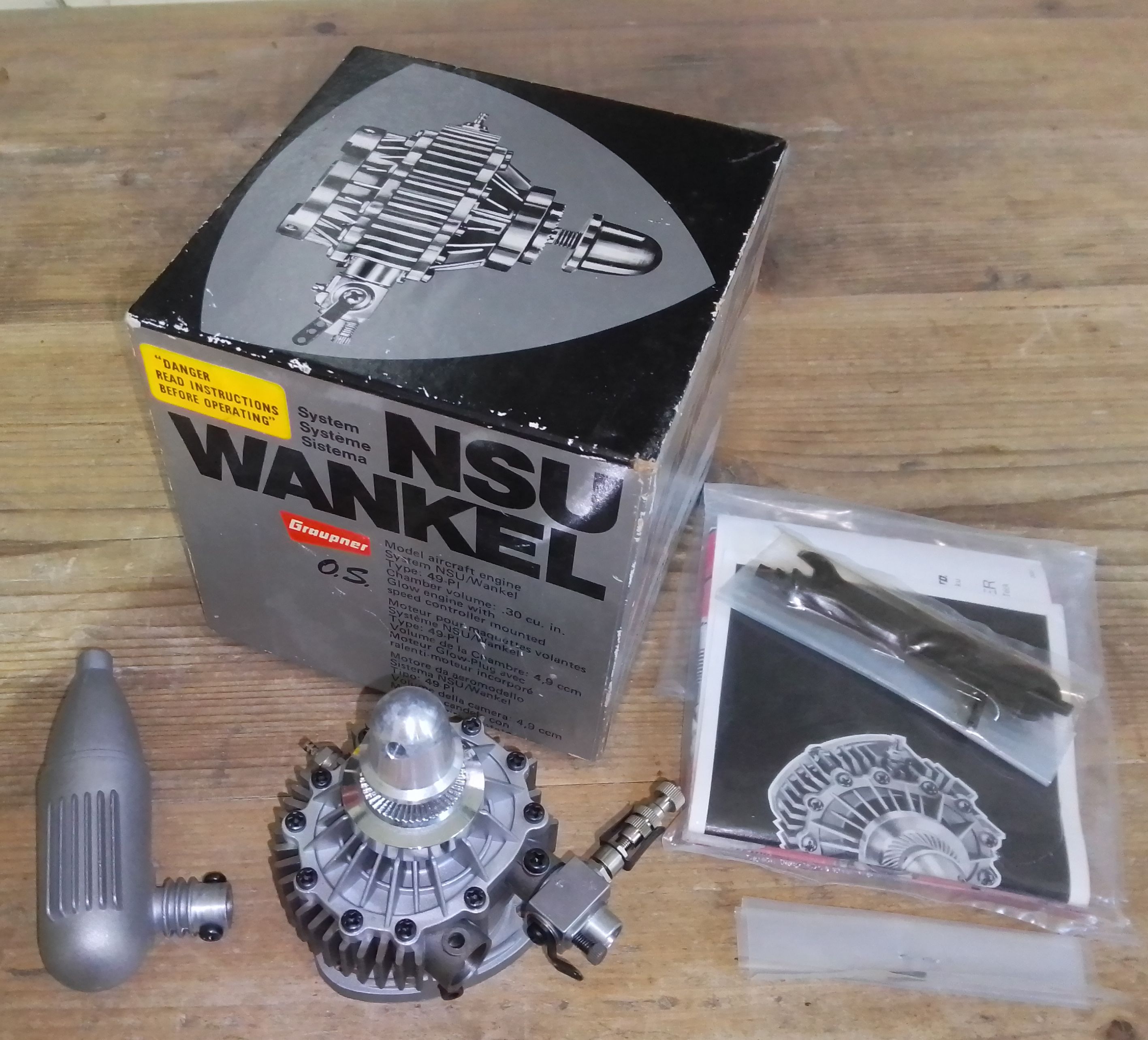 An NSU Wankel OS 49-PI radio control aeroplane engine with original box, appears unused.