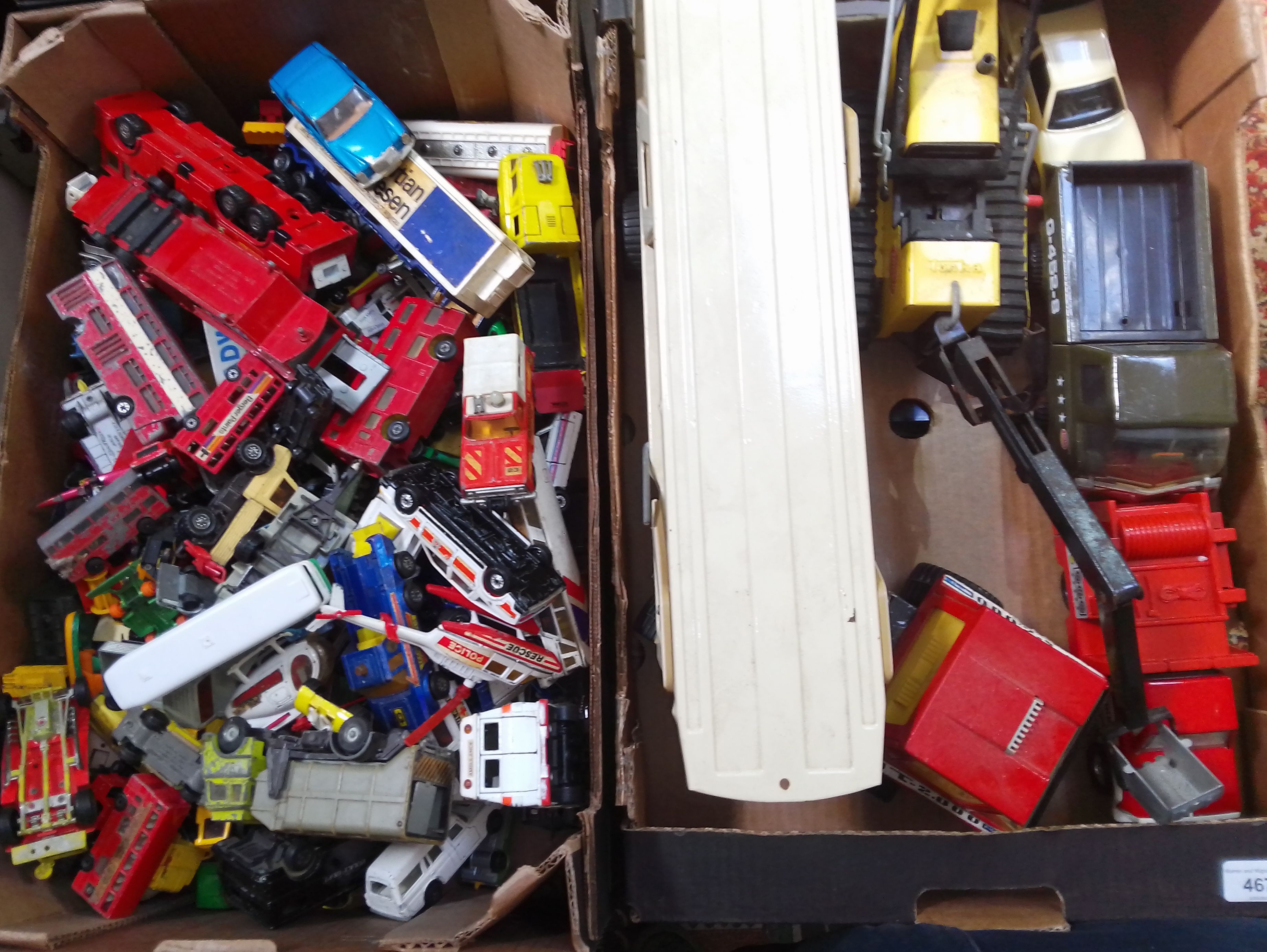 A box of die-cast model vehicles and a box of larger scale vehicles.