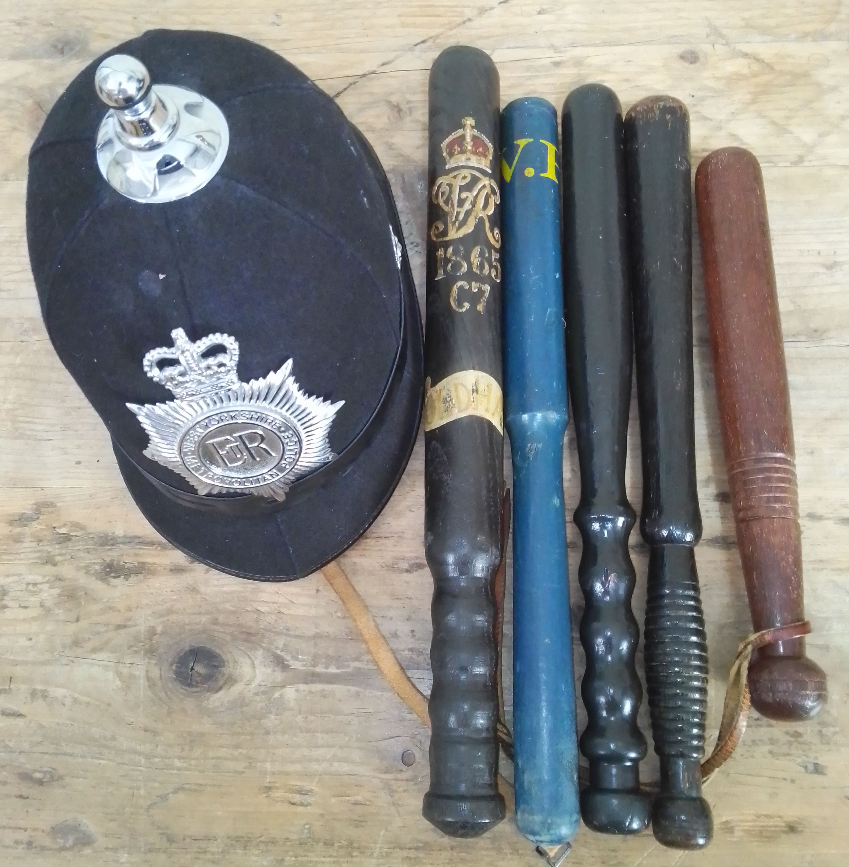 A West Yorkshire Metropolitan Police helmet together with five truncheons, one bearing decoration