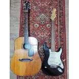 An Encore black electric guitar together with a Viva acoustic guitar, a Yamaha PSR-50 keyboard and
