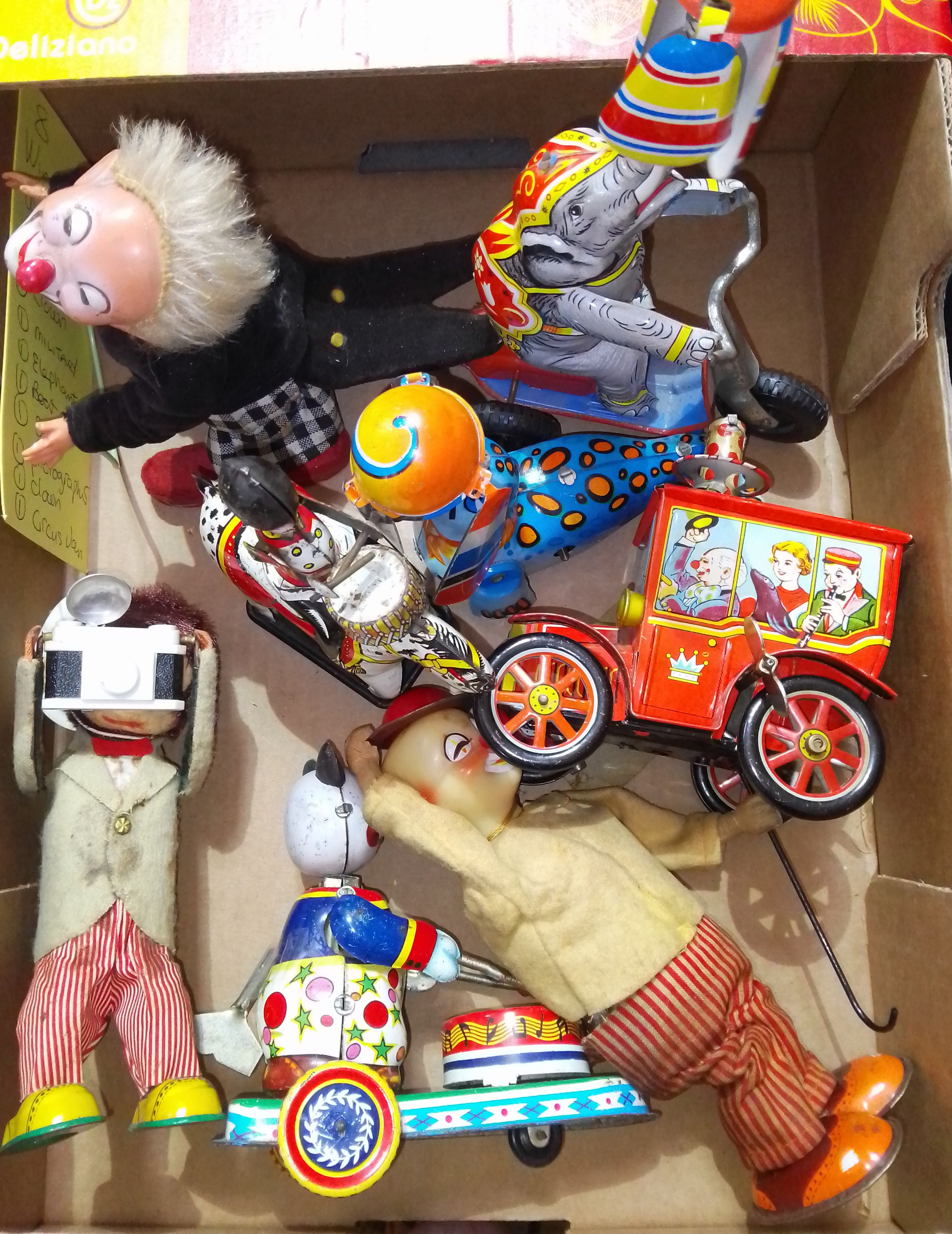 A group of eight tin plate wind up toys including Japanese, British and chinese.