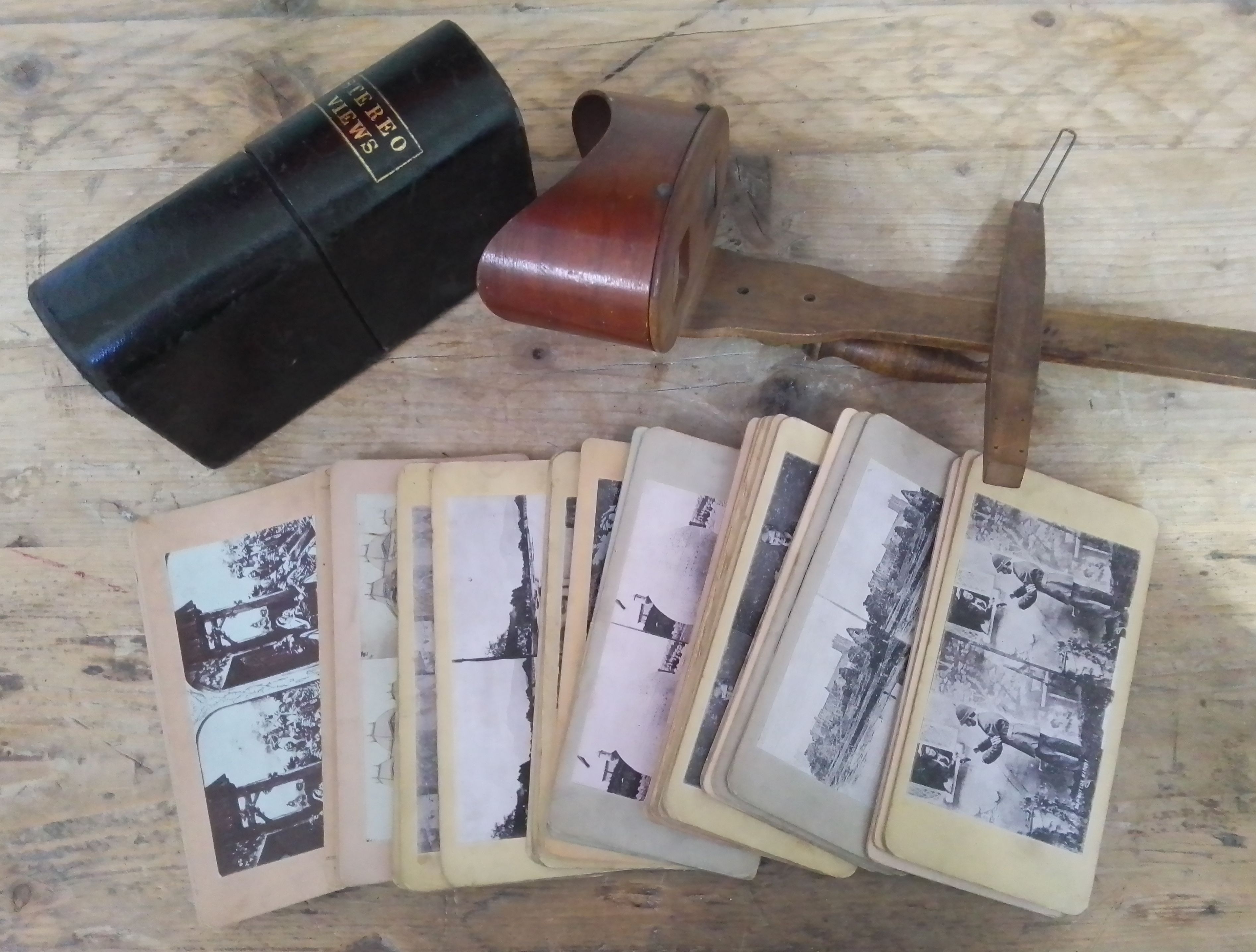 A leather bound case of stereo views and a hand held viewer.