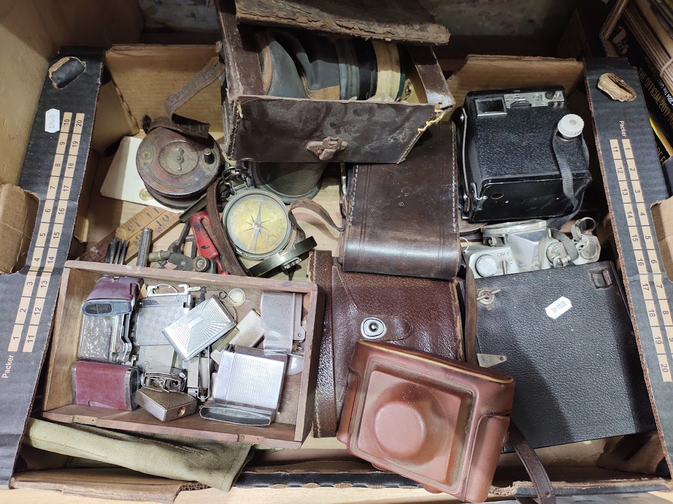 A box of mixed collectables including vintage cameras, cigarette lighters, binoculars, WWII era
