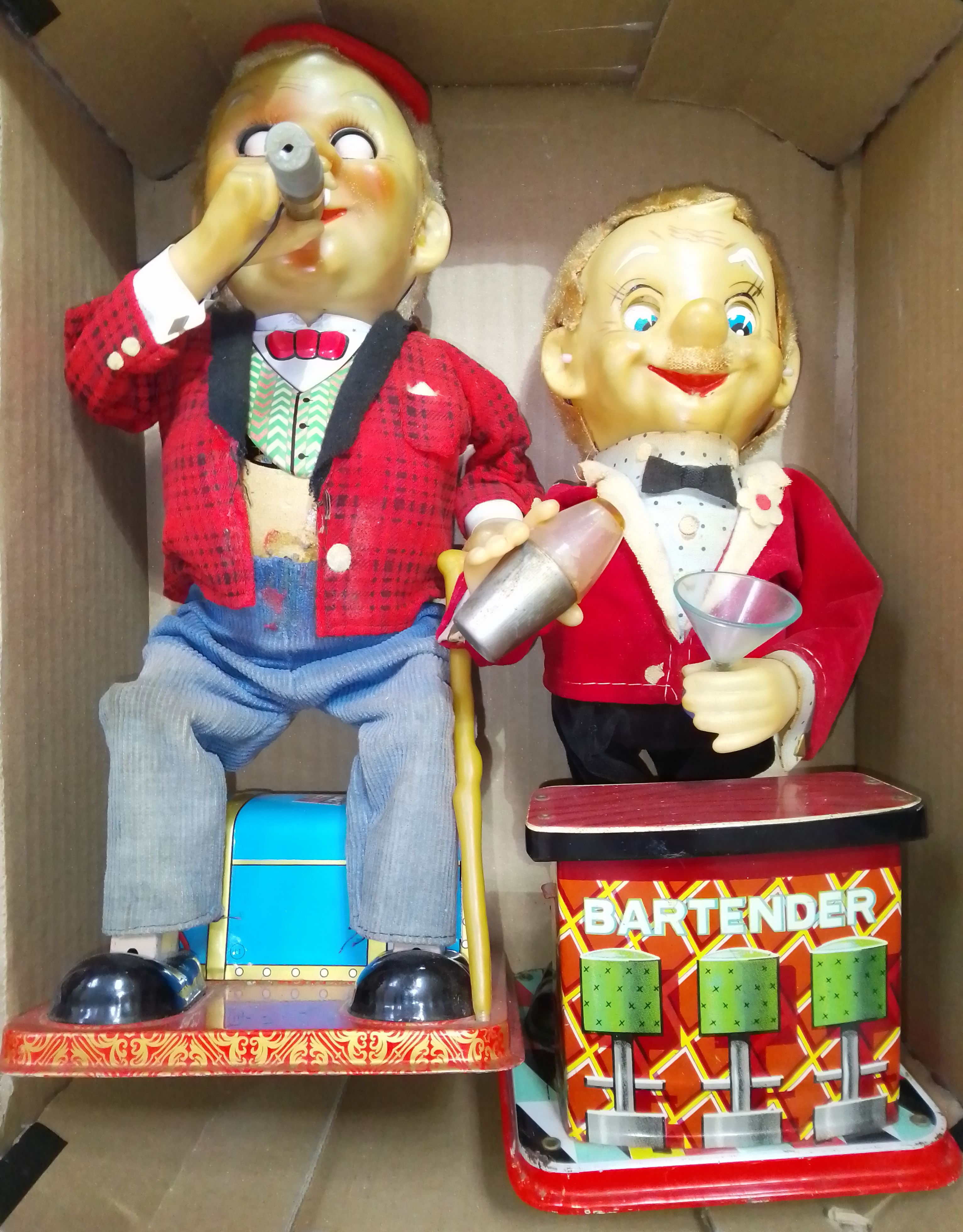Two Japanese mechanical tinplate toys comprising of a seated man with cigar & a bartender, both