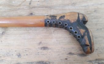 An antique walking stick, the handle modelled as a boot with brass eyelets, length 87cm.