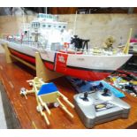 An RC plastic US Coast Guard boat, length 70cm, with wooden case.