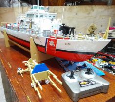 An RC plastic US Coast Guard boat, length 70cm, with wooden case.