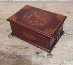 An Edwardian inlaid mahogany box with cast brass handles and feet.