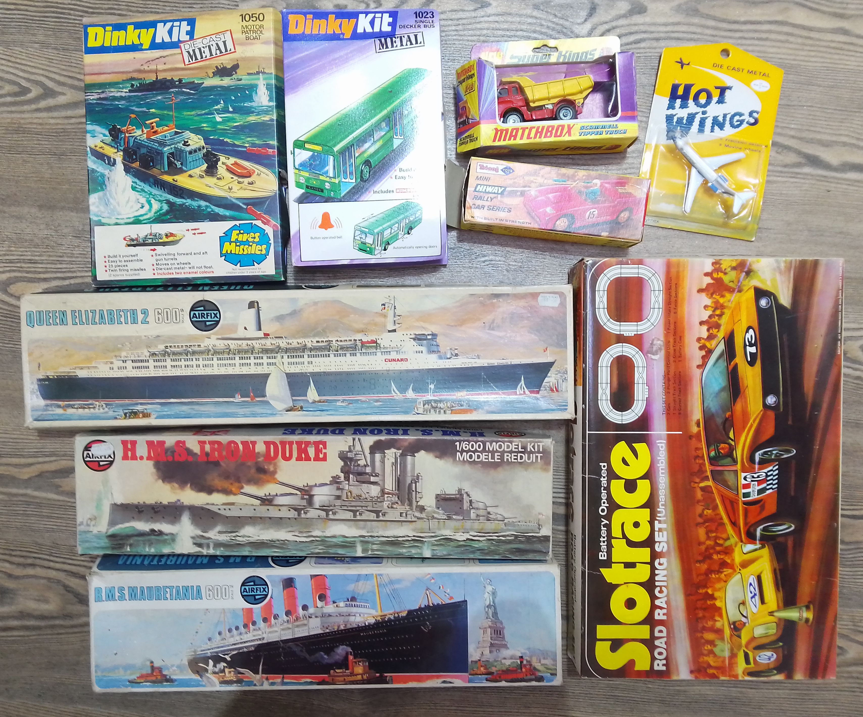 A box of assorted toys including a Triang die-cast Mini Hi-Way Rally Car Series, unbuilt Dinky and
