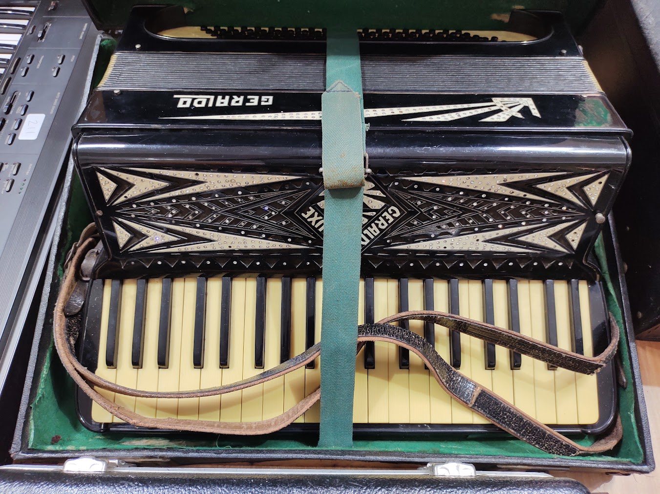 A Geraldo accordion in hard case.