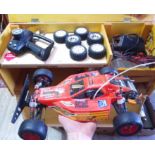 A Tamiya Orange Crush RC model car with wooden case and accessories.