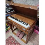 A Pearl River portable organ/harmonium in oak case, width 79cm.