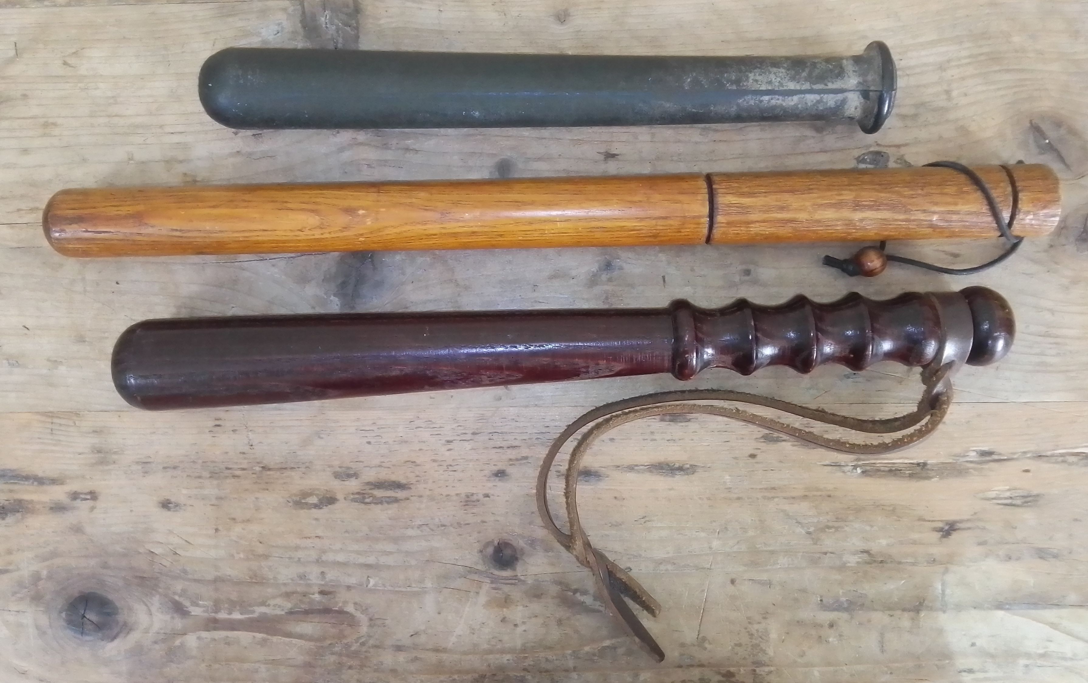 A group of three truncheons, lengths 31cm to 45cm.