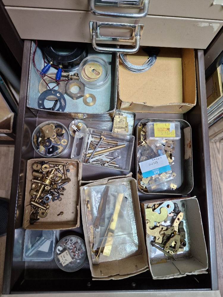 A 15 drawer triumph metal cabinet and contents comprising of clock making spares. - Image 13 of 16