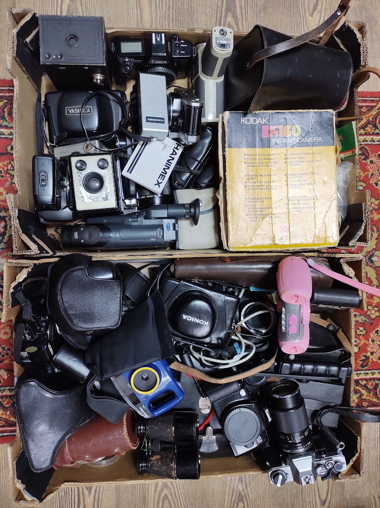 Two boxes of cameras, binoculars and accessories including Canon, Yashica, Olympus & Minolta 35mm