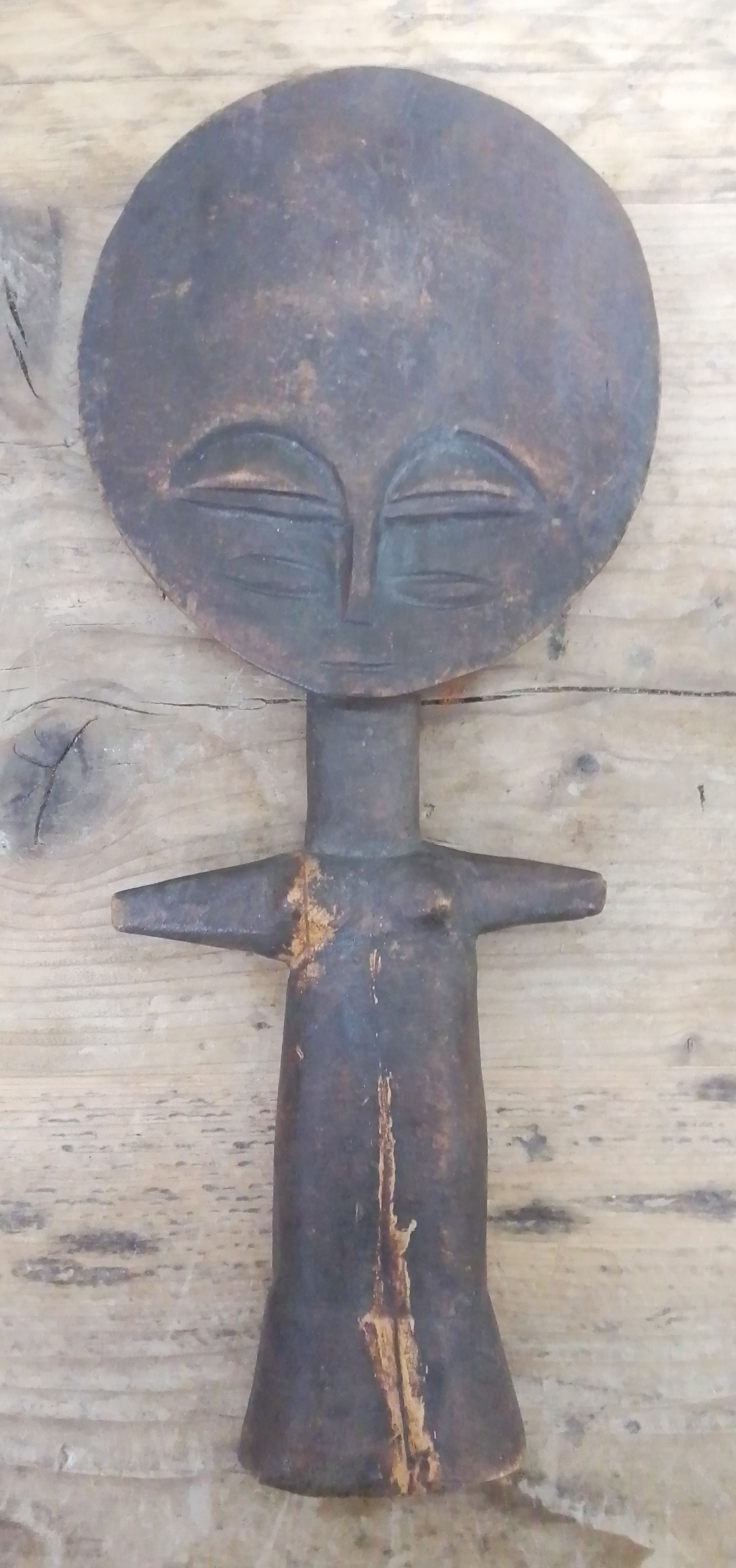 An Ashanti wooden fertility figure, length 29cm.