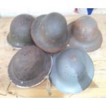 A group of five WWII helmets.