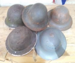 A group of five WWII helmets.