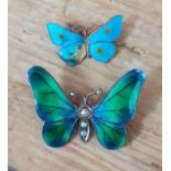 A hallmarked silver and enamel butterfly pendant and another marked 'Sterling'.