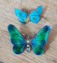 A hallmarked silver and enamel butterfly pendant and another marked 'Sterling'.