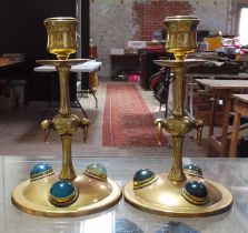 A pair of Gothic style copper and brass candlesticks set with hard stone cabochons, height 17cm.