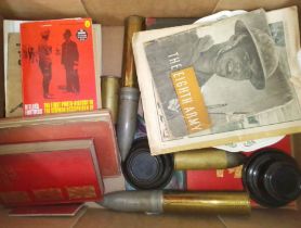 A box of assorted militaria including shell cases and ephemera etc.