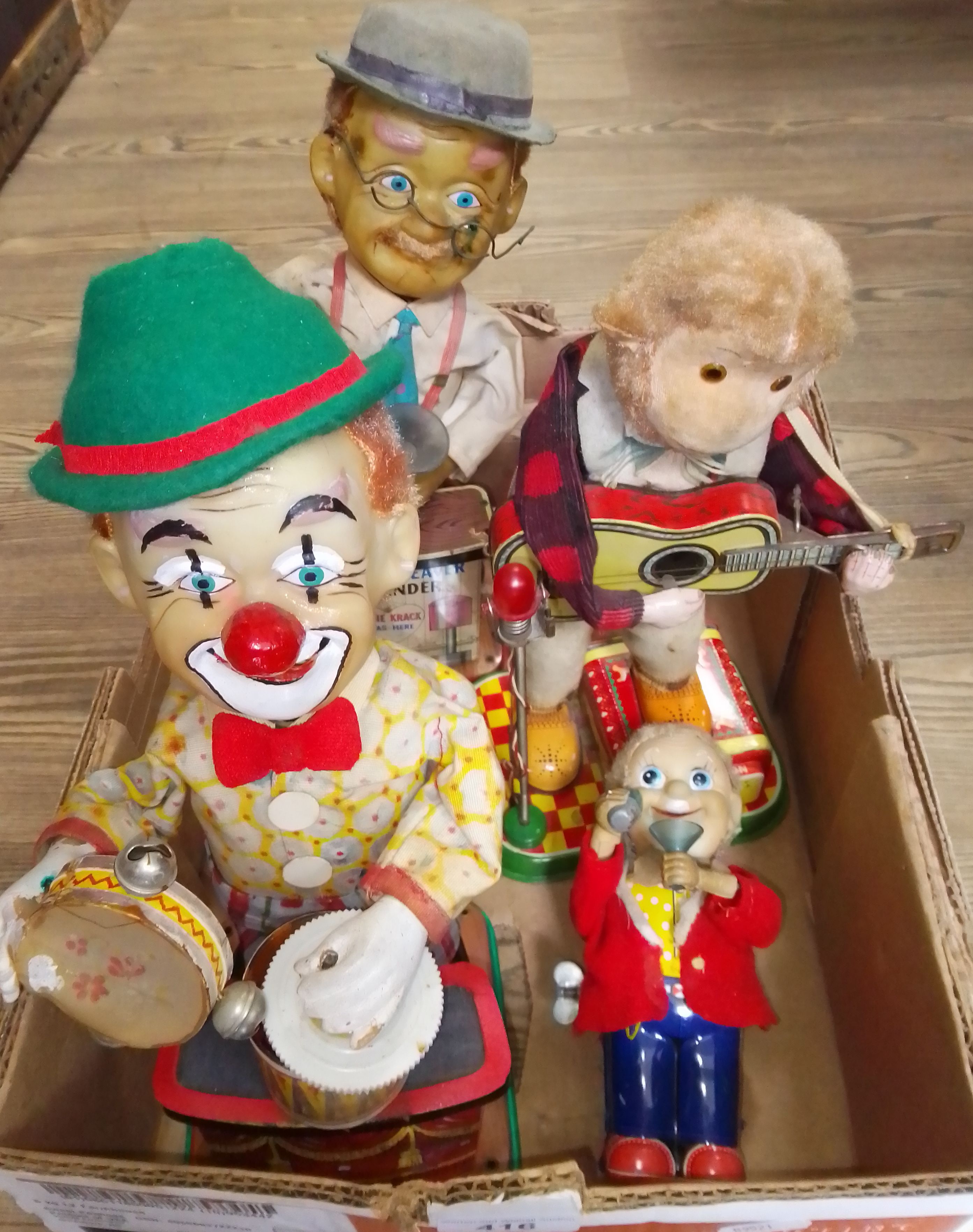 A group of three electric toys comprising a Charley weaver bartender and two musicians, together