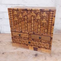 A Japanese parquetry inlaid miniautre cabinet.