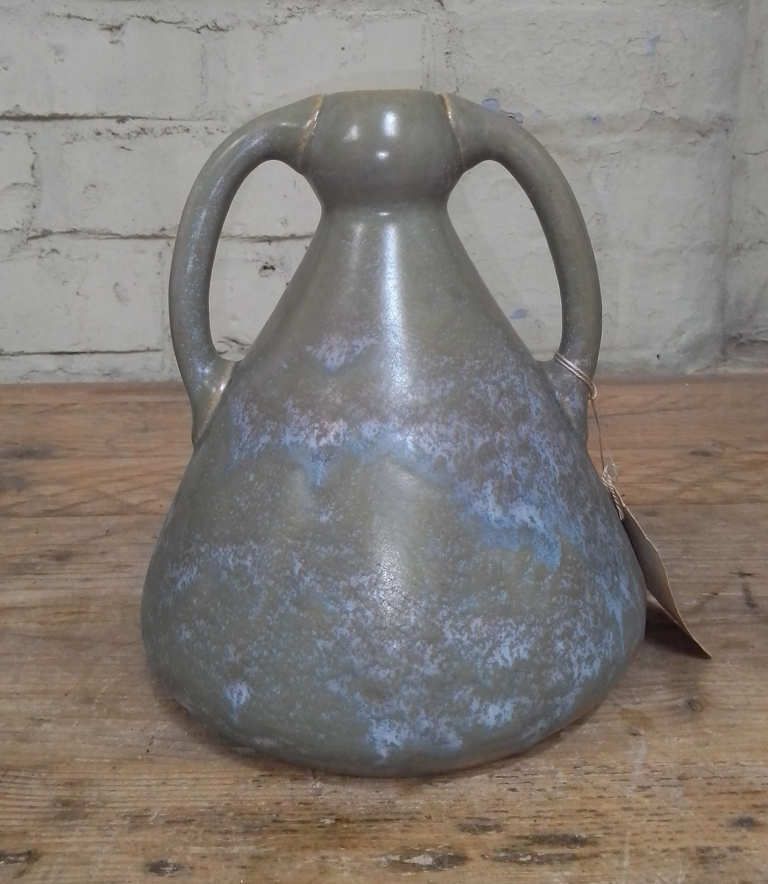 An Arts & Crafts pottery vase by Ashby Potters Guild, early 20th century, twin handled in mottled