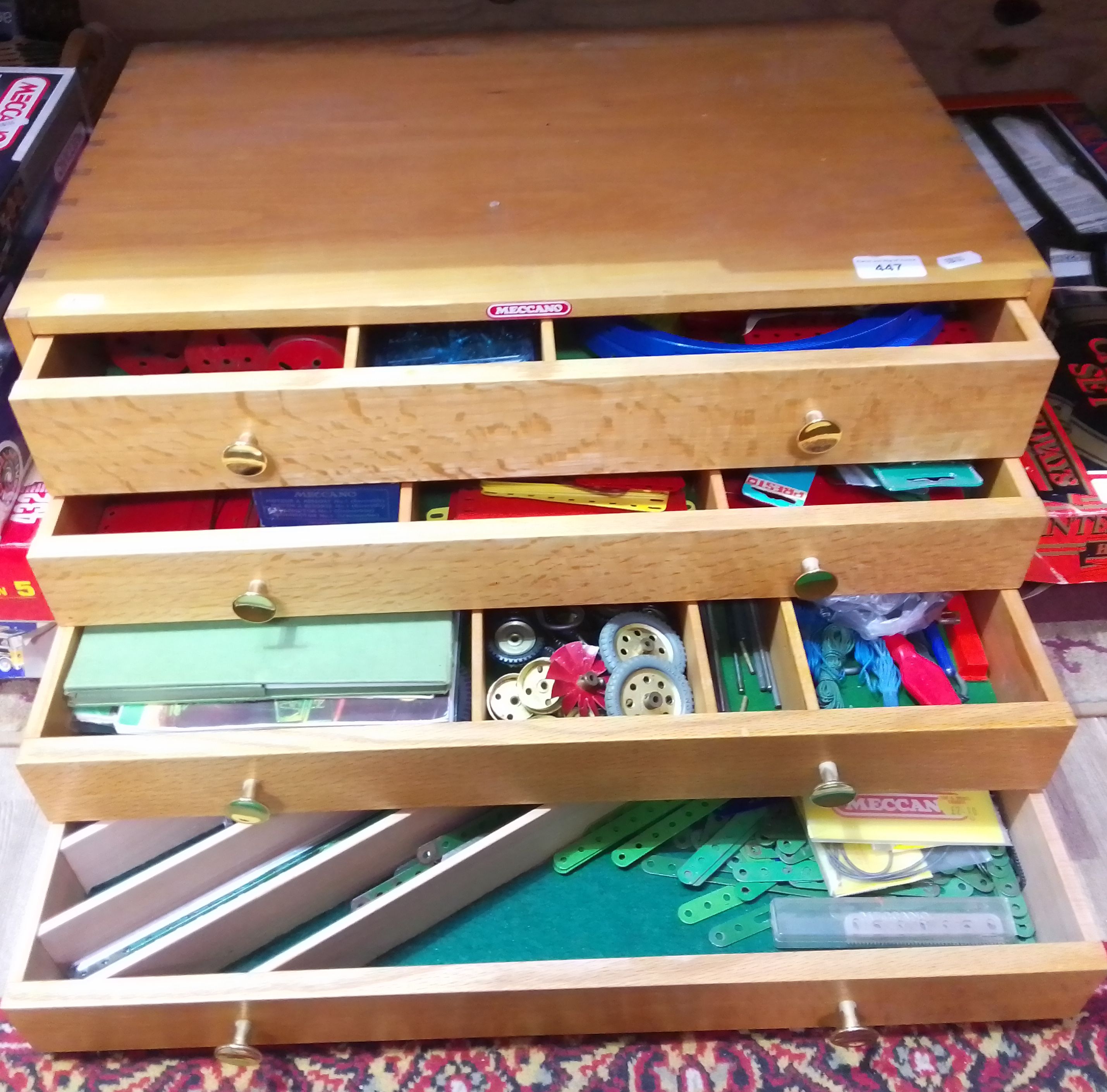 A Meccano four drawer wooden chest and contents including outfit no.10 instructions etc.