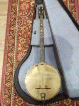 An early 20th century four string banjo, with hard case.