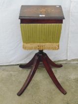 Victorian walnut work table with inlaid floral decoration to the lid, standing on a turned column