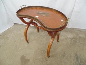 Kidney shaped tray top table with painted musical instrument and foliate decoration to top, brass