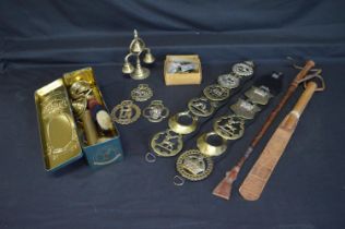 Quantity of horse brasses together with brass bell turrets, brass whip sockets and leather riding