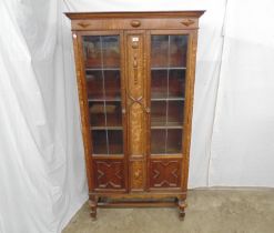 Oak two door leaded glazed bookcase with moulded decoration, the interior having four fixed
