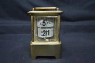 Unusual brass carriage clock with four bevelled glass panels and top carrying handle - 5" tall (