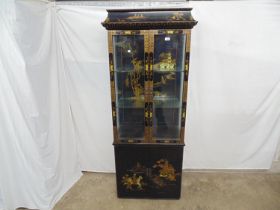 20th century Oriental style black lacquered display cabinet, the two glazed doors opening to an