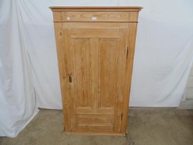 Pine cupboard, the single door opening to reveal two fixed shelves with hanging space over, standing
