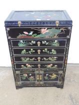 Oriental lacquered and painted chest of drawers with lift up top over four drawers and two