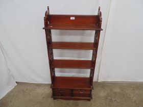 20th century hardwood open bookcase with three fixed shelves supported by pierced uprights over four