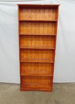 Stained pine bookcase having five fixed shelves and standing on plinth base - 76.5cm x 22cm x