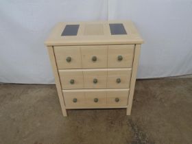 Modern chest of drawers having two pieces or granite inset to the top over three long drawers,