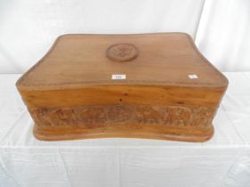 Carved shaped hardwood box the hinged lift top lid having a foliate border with raised central