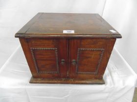 Oak table top two door cabinet having a hinged lift top lid to the top with shallow compartment