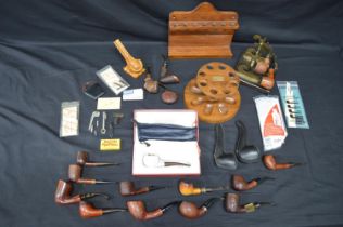 Collection of tobacco pipes and related items to include pipe rest, pipe racks etc Please note